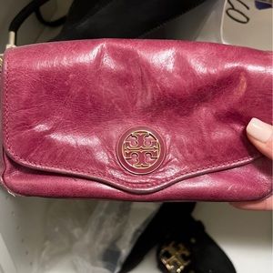 Fuchsia pink colored Tory Burch cross body with gold chain. In good condition.